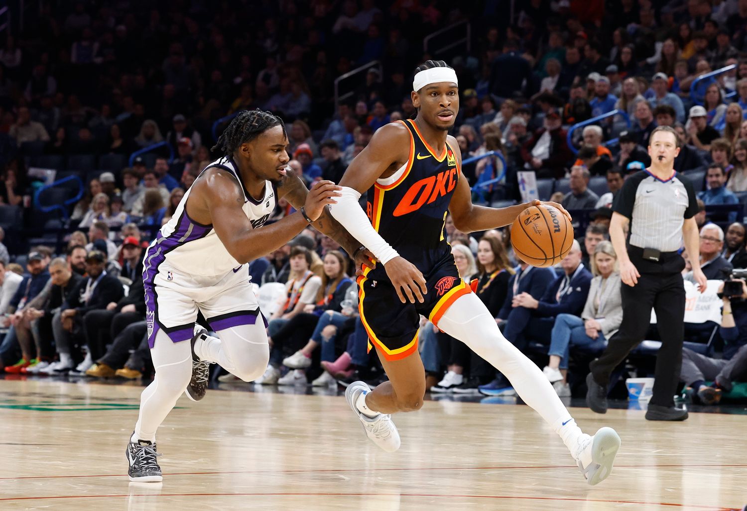 Feb 11, 2024; Oklahoma City, Oklahoma, USA; Oklahoma City Thunder guard Shai Gilgeous-Alexander (2) drives to the basket beside Sacramento Kings guard Davion Mitchell (15) during the second half at Paycom Center. Mandatory Credit: Alonzo Adams-USA TODAY Sports  